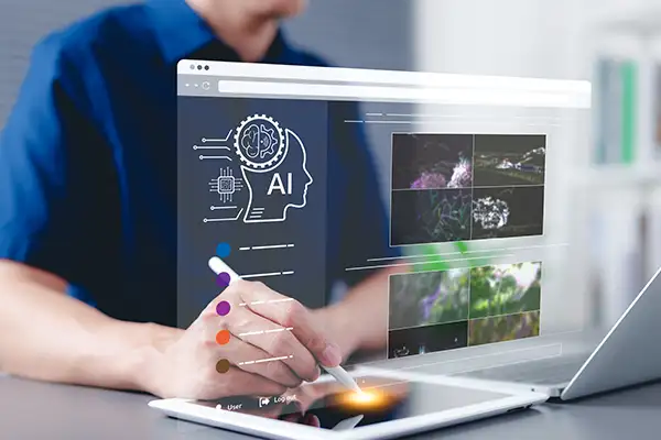 Person using an image generation tool with tablet and laptop